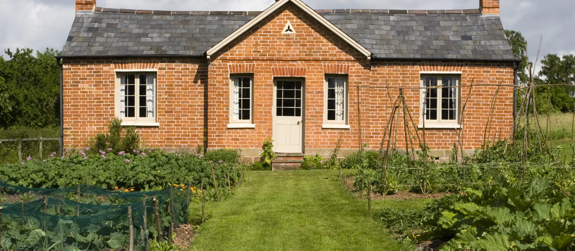 A historic house located in the middle of some crops
